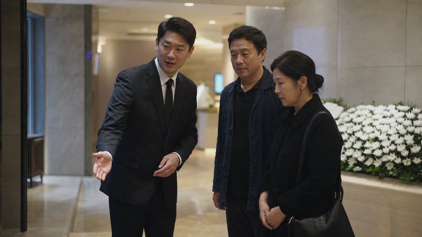 장례식장 로비에서 유가족을 맞이하는 장례지도사