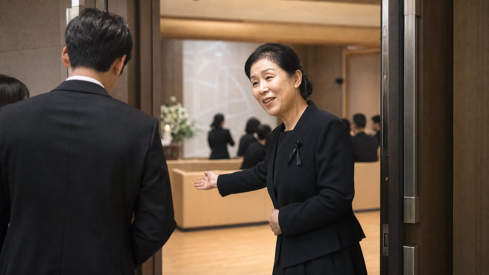 접객실 입구에서 조문객에게 자리를 안내하는 상주